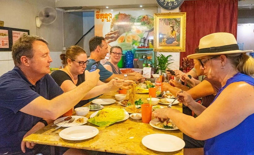 Phnom Penh: Night Foodie Tour by Tuk Tuk with Drinks - Night Market wandering: photos, stalls, and street-snack energy