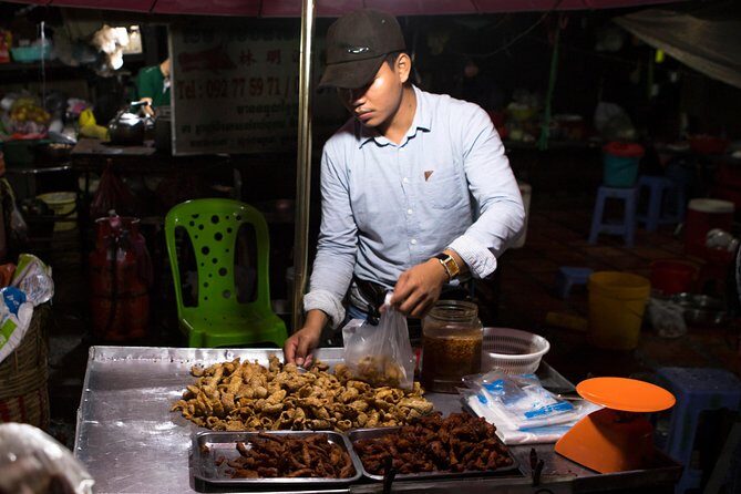 Ultimate Phnom Penh Food Tour by Tuk Tuk: 20 Tastings and Drinks - Stop 4: Russian Market at night and the smoky pork ribs payoff